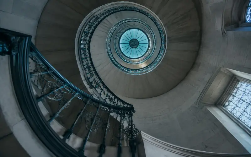A courthouse spiral staircase seen from below, with no people